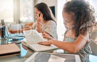 Distance learning, independent or child development of a little girl studying from home and writing in a notebook. Young child doing online education with a busy mother or single parent