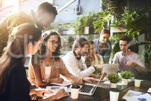 Brainstorming with a breath of fresh air. a group of colleagues having a meeting outside at a cafe.