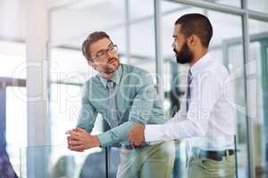 Hes a great manager to talk to. colleagues having a discussion in a modern office.