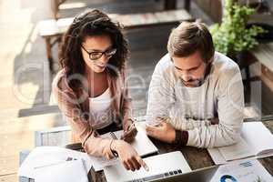 This plan is sure to work the best for us. two designers having a meeting at a coffee shop.