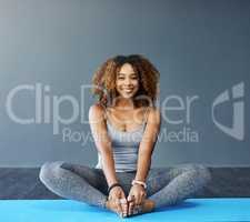 My happiness is my responsibility. a young woman practicing yoga in the studio.