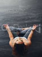 You wont win if you not right within. High angle shot of a young woman practising yoga.