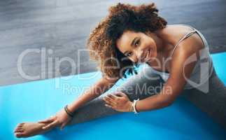 Stretch and watch how you will stress less. High angle shot of a young woman practising yoga.