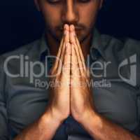 Give us this day our daily bread. Closeup shot of a young man praying with his eyes closed.