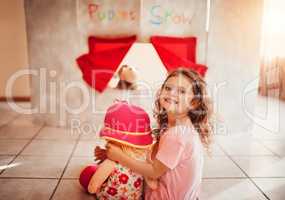 The puppet show is about to start. Portrait of a n adorable little girl watching a puppet show at home.