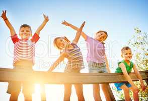 Time for some endless fun in the sun. Portrait of a group of little children playing together outdoors.