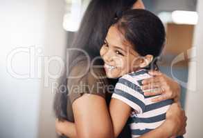 Nothing says comfort like a hug from mom. a happy mother and daughter in a warm embrace at home.