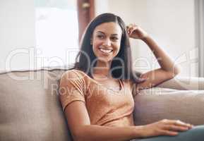 The perfect spot to unwind. a happy young woman enjoying a relaxing day on the sofa at home.