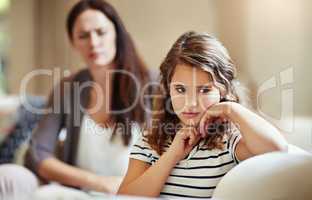 This is where discipline starts. a young girl being reprimanded by her mother at home.