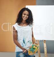 Art is passion on paper. Portrait of an attractive young woman painting on a canvas at home.