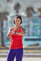 Getting favorable results from her workout. a sporty young woman measuring her pulse.