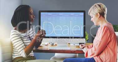 Putting their heads together for a quick brainstorming session. two businesswomen brainstorming together in an office.