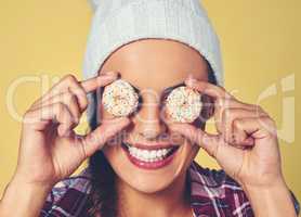 Dont be eye candy, be soul food. a young woman covering her eyes with cookies against a colorful background.