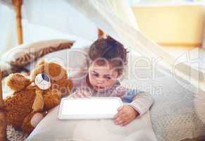 Kids are quick to grasp technology nowadays. an adorable little girl using a digital tablet at home.