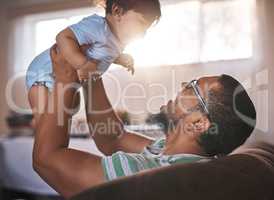 Bonding with his adorable baby boy. a father bonding with his baby son at home.