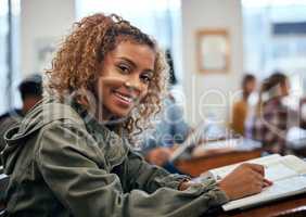 Shes happy because she studied hard for this test. university students sitting in class.