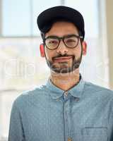 Meet the walking definition of cool and casual. Portrait of a confident young man standing indoors.