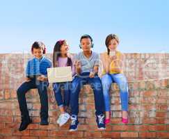 Children are the greatest treasures, they are the future. a diverse group of children having fun with technology outside.