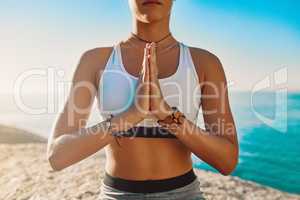Dont give away your power. an athletic young woman practicing yoga on the beach.