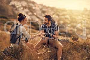 I love this one. a couple looking at pictures on their camera while out on a hiking trip.