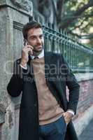 Ill be back in the office shortly. a handsome businessman using his cellphone while about town.