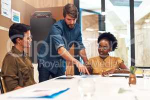 Working hard to increase their chances of success. a diverse group of businesspeople having a meeting in an office.