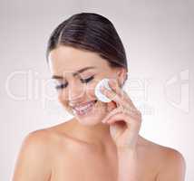 Wipe your way to flawless skin. Studio shot of an attractive woman posing against a grey background.