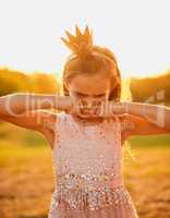 No, playtime cant be over yet. an adorable little girl playing outdoors.