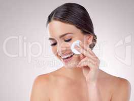 Wipe the blemishes away for clean and clear skin. Studio shot of an attractive woman posing against a grey background.