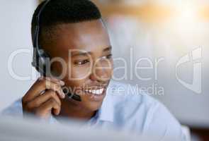 Satisfied customers are the best business strategy of all. a male agent working in a call centre.
