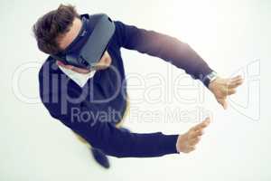 Change the way you see and experience the world. High angle shot of a businessman wearing a VR headset in an office.