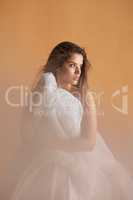 True alphas dont feel threatened by anyone. Portrait of a beautiful young woman covering herself with a ballet skirt in studio.