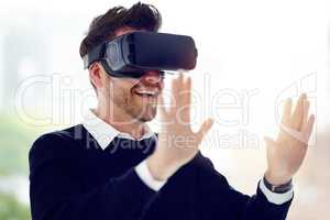 New possibilities are always within reach. a businessman wearing a VR headset in an office.