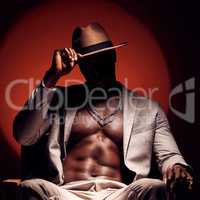 Silhouette of dark, hiding and secret man with art deco in red light studio background. Creative, fashion and muscular African model with shadow looking trendy, confident and seductive in suit
