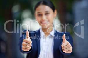 Thumbs up, blurred and working woman does agree by doing hand gesture to express she is happy. Employee likes and smiles about good news about reaching best professional career goal at work.