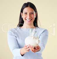 Woman excited for financial investment, savings and planning for future investment, holding piggybank and smiling. Banking money, success and finance profit, budget cash notes for financial growth