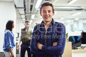 I have some big dreams to achieve. Portrait of a young designer standing in an office with his colleagues in the background.