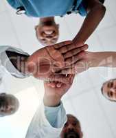 Goal of a group of doctors with their hands together in support, unity and trust together ready for surgery in hospital. Below view of medical team or healthcare professionals winning and celebrating