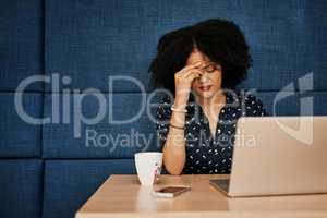 How am I going to get this all done. a young female designer looking stressed while trying to work on her laptop at the office.