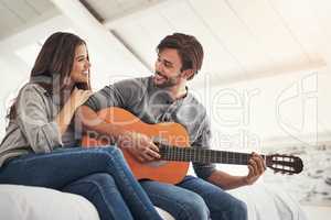 I find pieces of you in every song I play. an attractive young couple spending quality time at home.