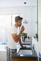 Clean the entire mouth correctly to avoid the dentist. a handsome man brushing his teeth in the bathroom at home.