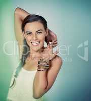 Her hairstyle will make you green with envy. Studio shot of a beautiful young woman posing against a green background.