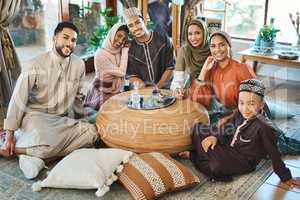Happy muslim family celebrating ramadan together, smiling and bonding in living room. Relaxed relatives spending the day embracing religious holiday. Islamic siblings gathering in their family house