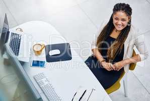 Ive got the top in sight. High angle portrait of an attractive young businesswoman sitting at her desk in the office.
