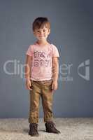 Boys wear pink too. Studio portrait of a boy wearing a t shirt with Im a boy printed on it against a gray background.