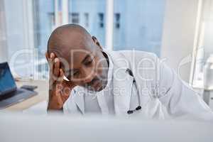 Stress, anxiety and sad doctor at work on computer, sick and headache in a hospital or clinic. Medical professional or healthcare worker in depression, burnout and working and thinking about health.
