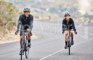 Cycling, couple goals and fitness while riding bicycle on countryside road for health and exercise. Happy male and female cyclists and athletes looking happy while training for sports race or hobby