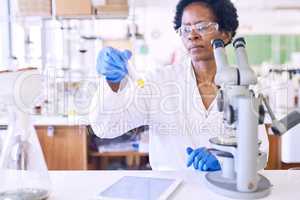 The world of science is filled with curiosity. a female scientist working in a lab.