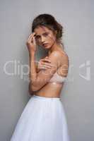 Show them youre fierce. Portrait of a beautiful young woman posing in studio while wearing a bra and ballet skirt.