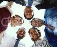 Were not known as a high-performance team for nothing. Portrait of a diverse group of businesspeople putting their heads together in a huddle.